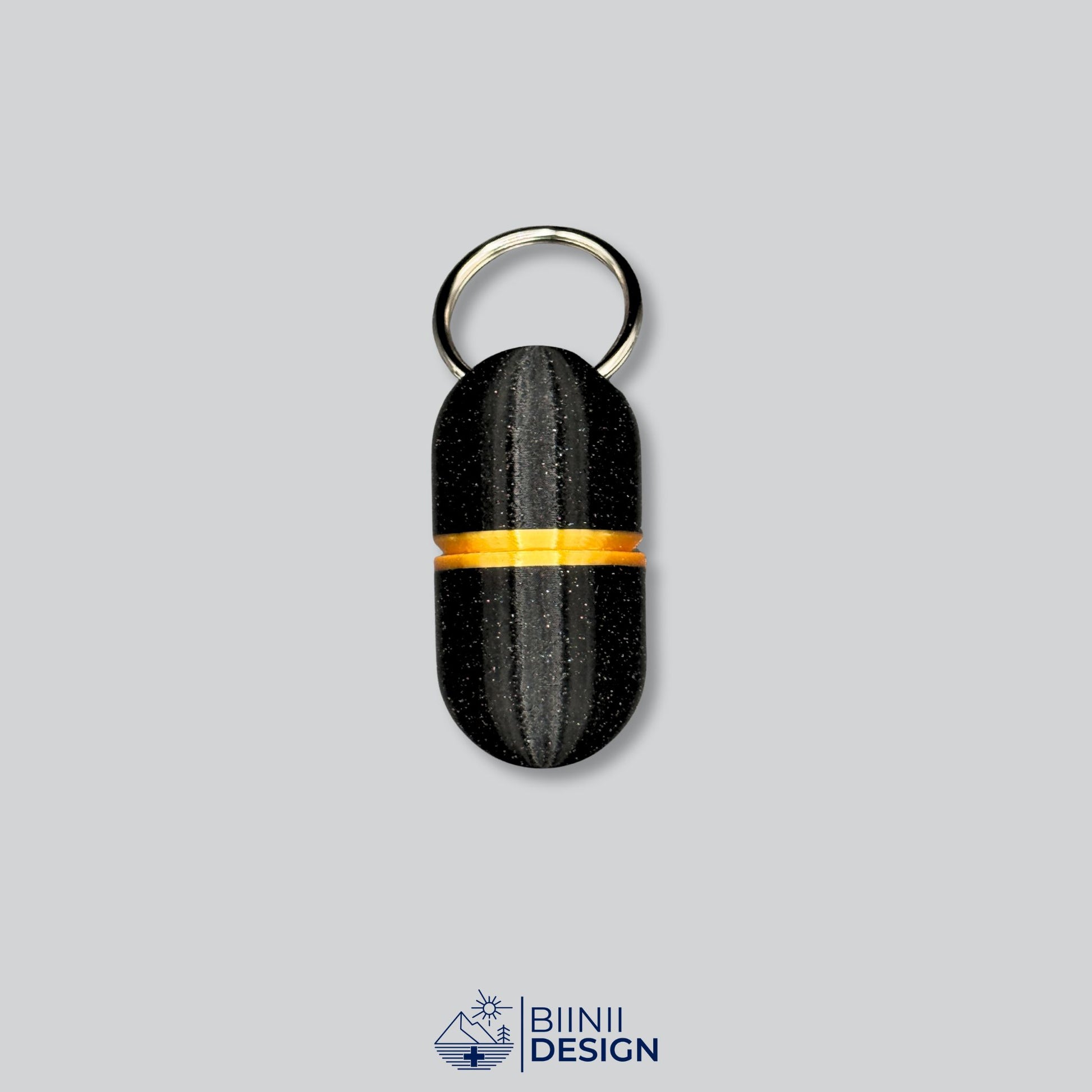 Keychain-sized deluxe pillbox with black galaxy body and gold accent, ideal for vitamins, painkillers, or supplements.
Keywords: travel pill holder, deluxe keyring capsule case, compact pill organizer, Biinii Design