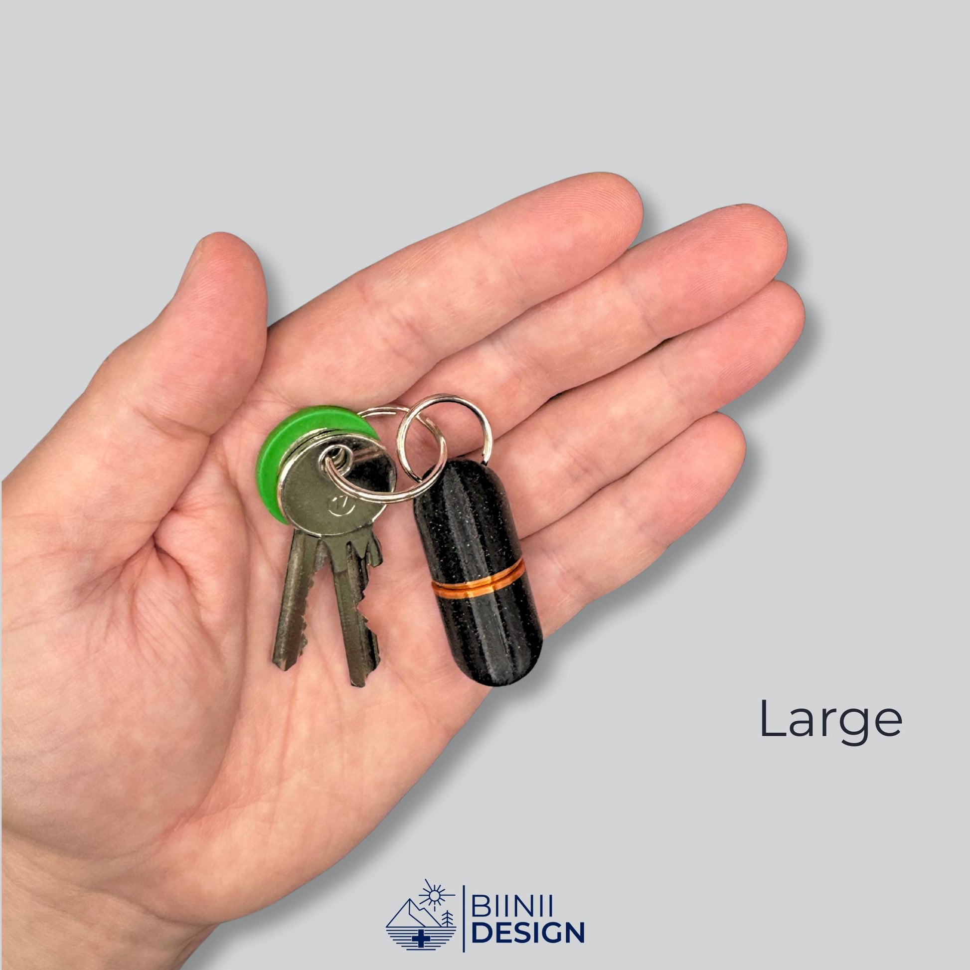 Large deluxe keyring pill case in black with copper band, held in palm with keys for scale. Perfect for daily meds and emergency pills.
Keywords: large pill organizer, keychain pill container, emergency pill case, deluxe supplement holder, Biinii Design
