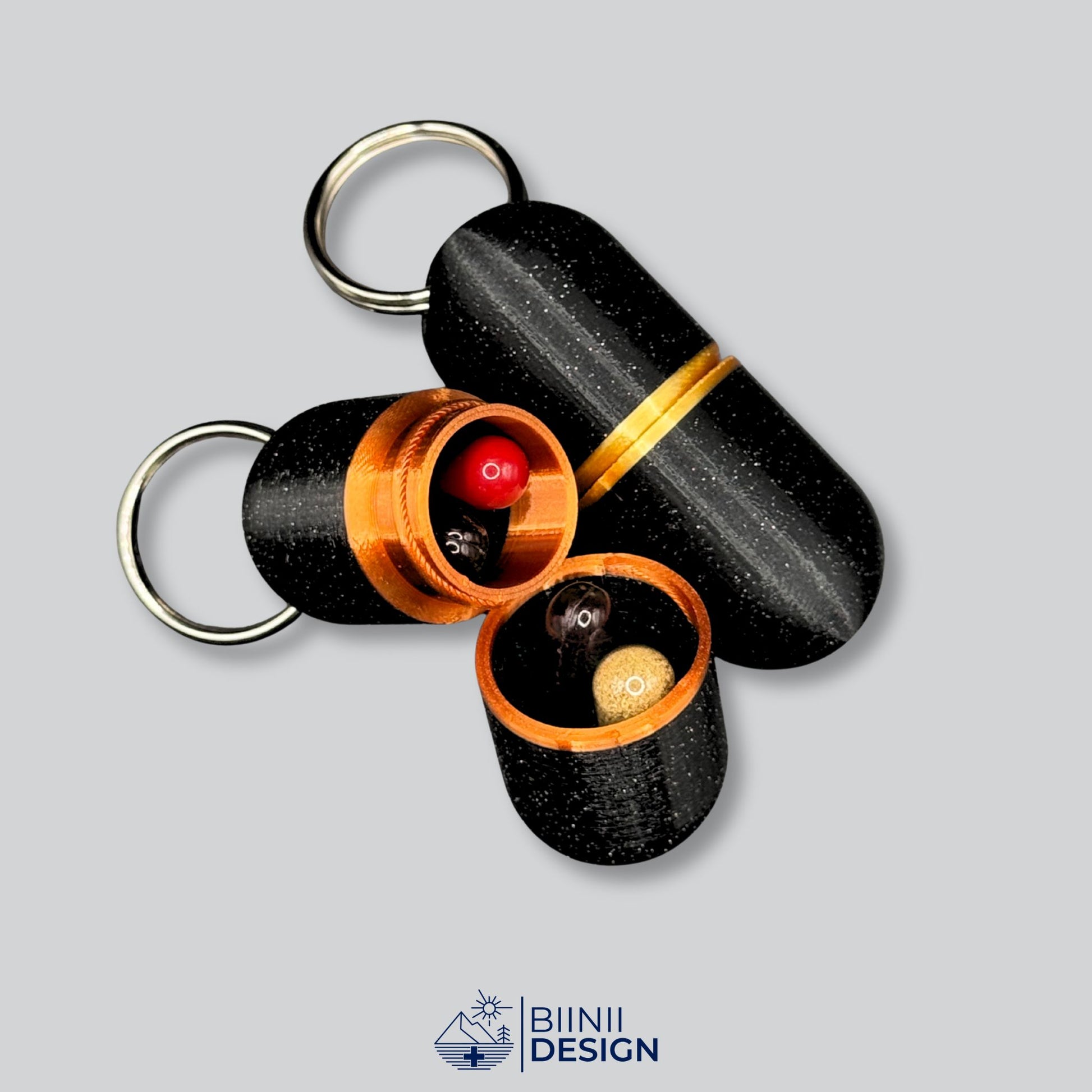Open deluxe keyring pill case in black and gold, filled with capsules, illustrating daily pill storage with sleek closure.
Keywords: deluxe pill container, capsule holder, keychain pillbox, daily med organizer, Biinii Design