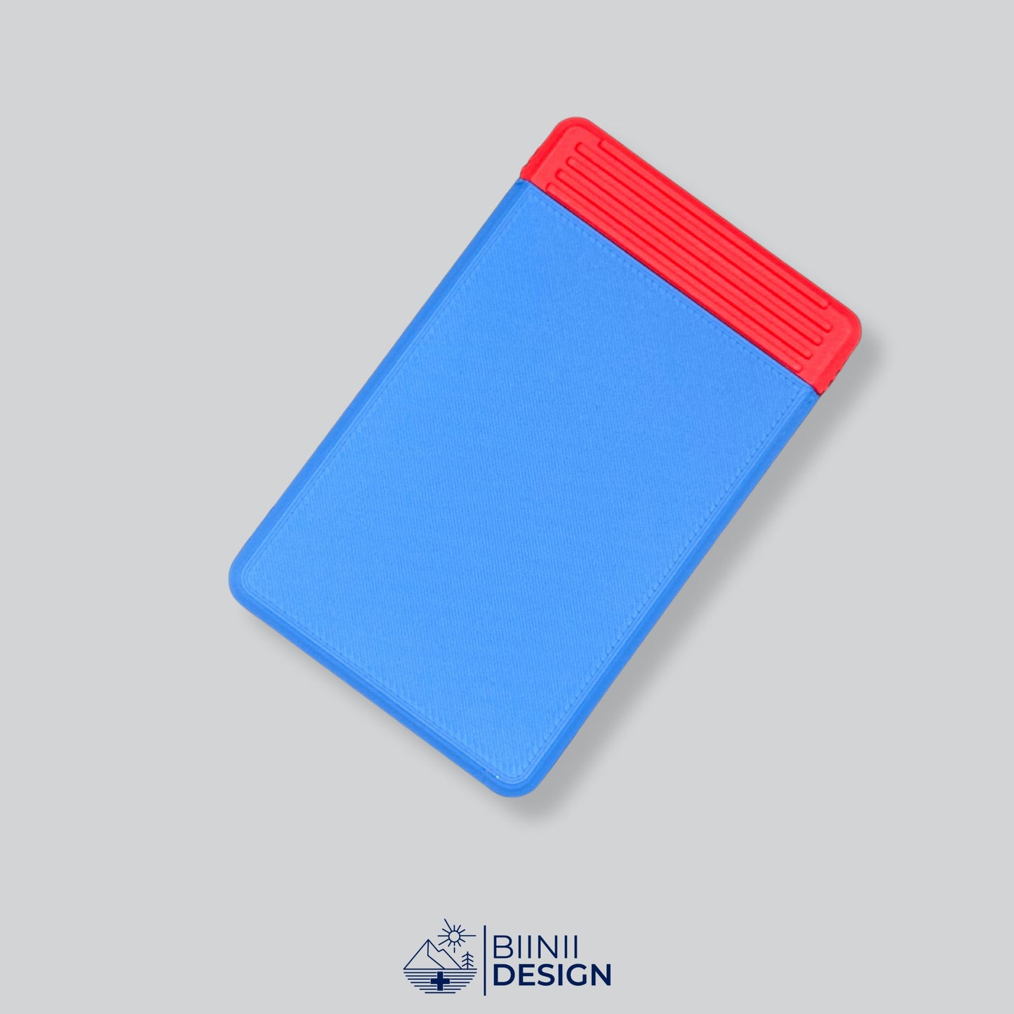 Blue/Red two-tone compact travel pill holder, ideal for supplements and vitamins and presented as a Designed in Switzerland Biinii Design piece.