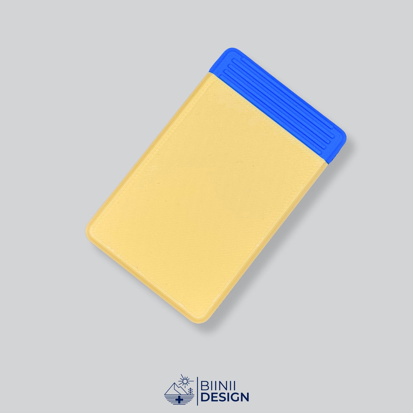 Yellow/Blue two-tone discreet 4-compartment pill organizer, ideal for complex medication plans and presented as a Designed in Switzerland Biinii Design piece.