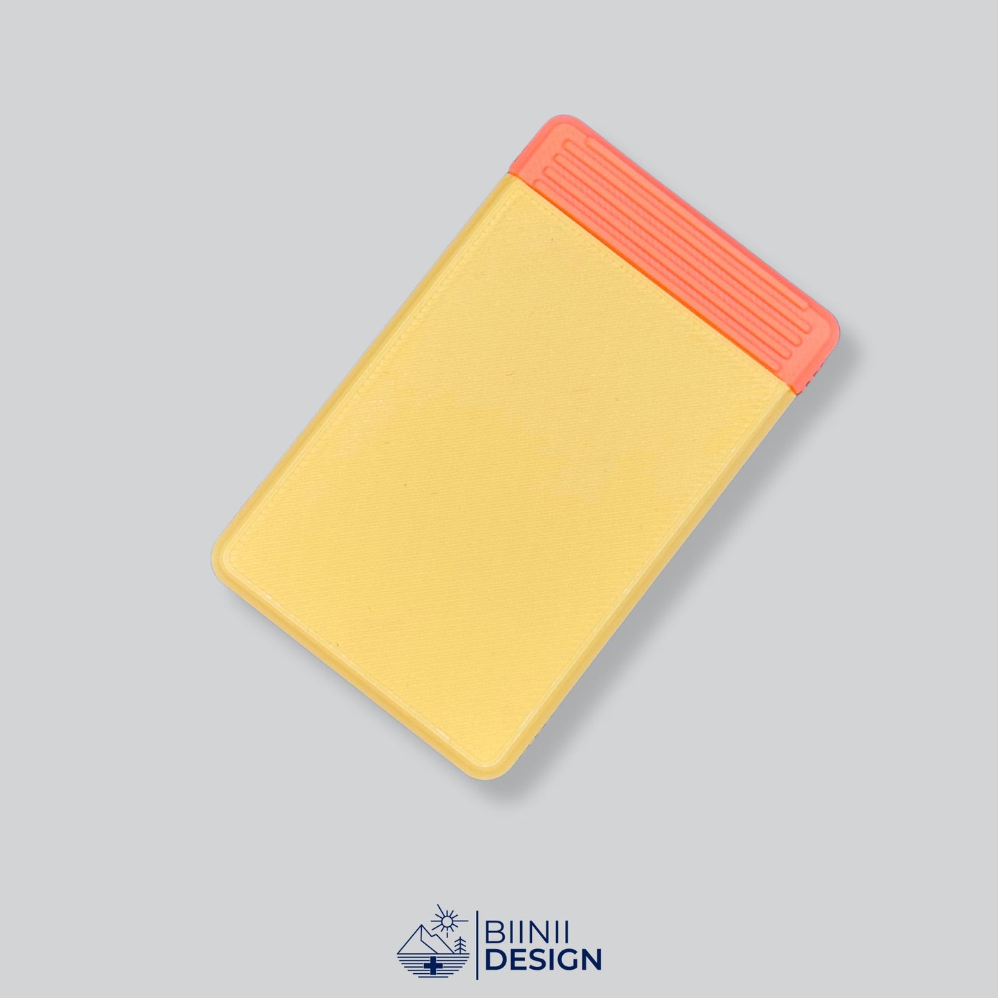 A functional Yellow/Orange two-tone daily premium pill holder, perfect for compact organization on the go, a Designed in Switzerland Biinii Design piece.