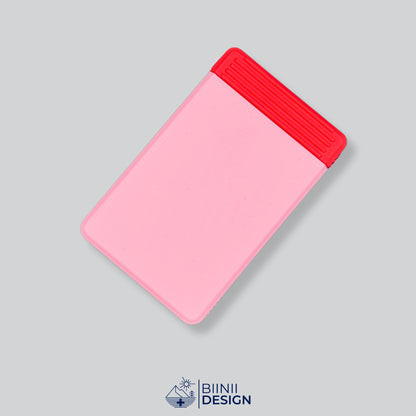 Semainier compact avec couvercle rose et base rouge, départ dimanche ou lundi.