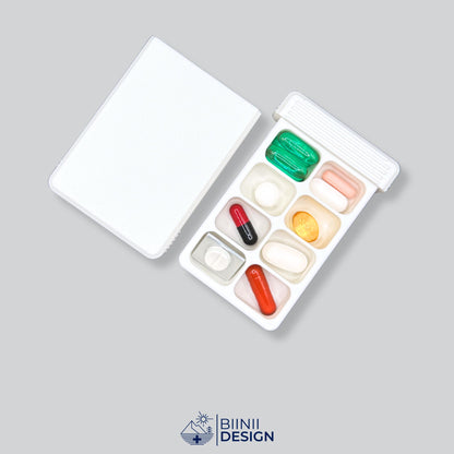 Open travel pill box, its eight compartments in two rows filled with tablets, capsules and supplements.