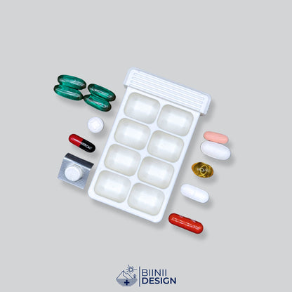 Eight-compartment travel pill box with pills laid out, one compartment per day or per dose on the days away.