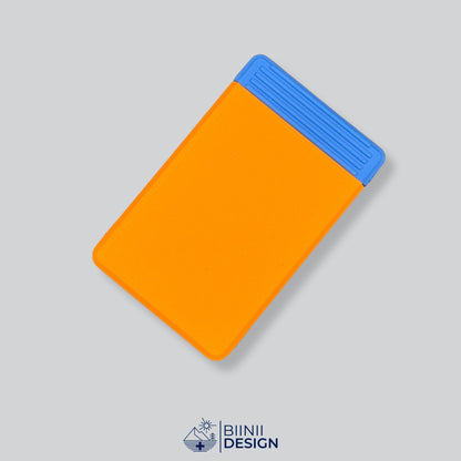 Double-row travel pill box with an orange lid and a blue base, eight compartments for the days away.
