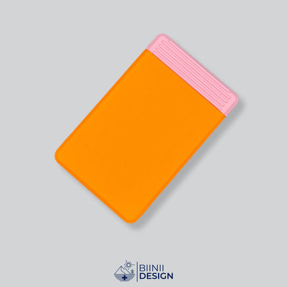 Double-row travel pill box with an orange lid and a pink base, eight compartments for the days away.