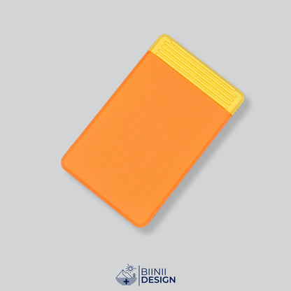 Double-row travel pill box with an orange lid and a yellow base, eight compartments for the days away.