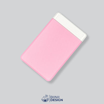 Double-row travel pill box with a pink lid and a white base, eight compartments for the days away.