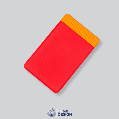 Double-row travel pill box with a red lid and an orange base, eight compartments for the days away.