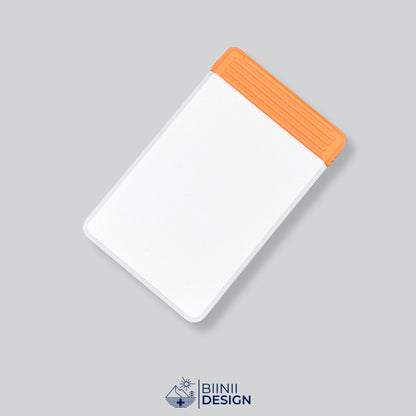 Double-row travel pill box with a white lid and an orange base, eight compartments for the days away.