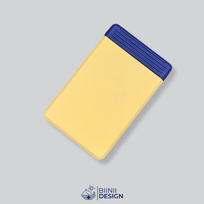 Double-row travel pill box with a yellow lid and a black base, eight compartments for the days away.