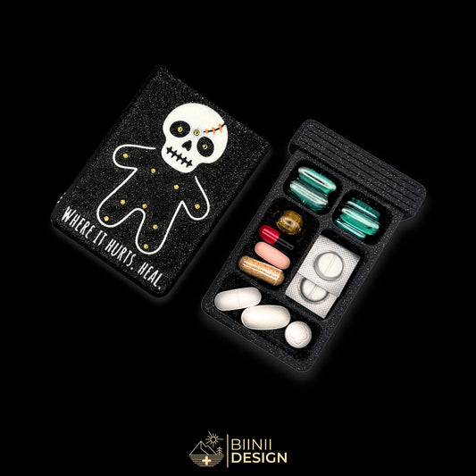 Healing Voodoo mystic pill organizer cover beside 5-compartment tray. Secure slide closure filled with supplements and medicines.