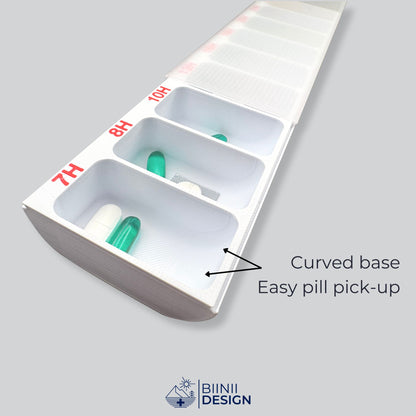 Three open compartments of the hourly pill organizer with capsules, softgels and a cut blister, the curved base for easy pill pick-up.