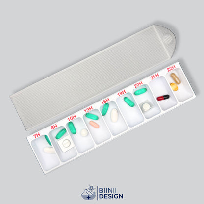Hourly pill organizer in white PETG, 24-hour format, its translucent lid beside the base filled with tablets, capsules, softgels and cut blisters.
