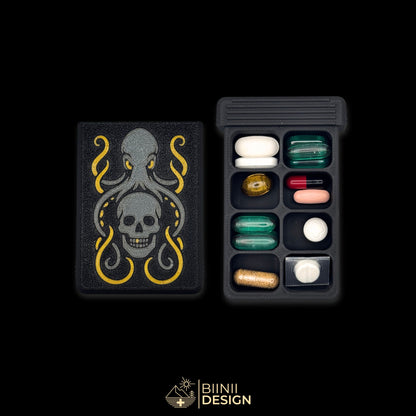 Kraken's Whisper art edition pill organizer lid beside a filled 8-compartment base holding tablets, capsules and supplements.