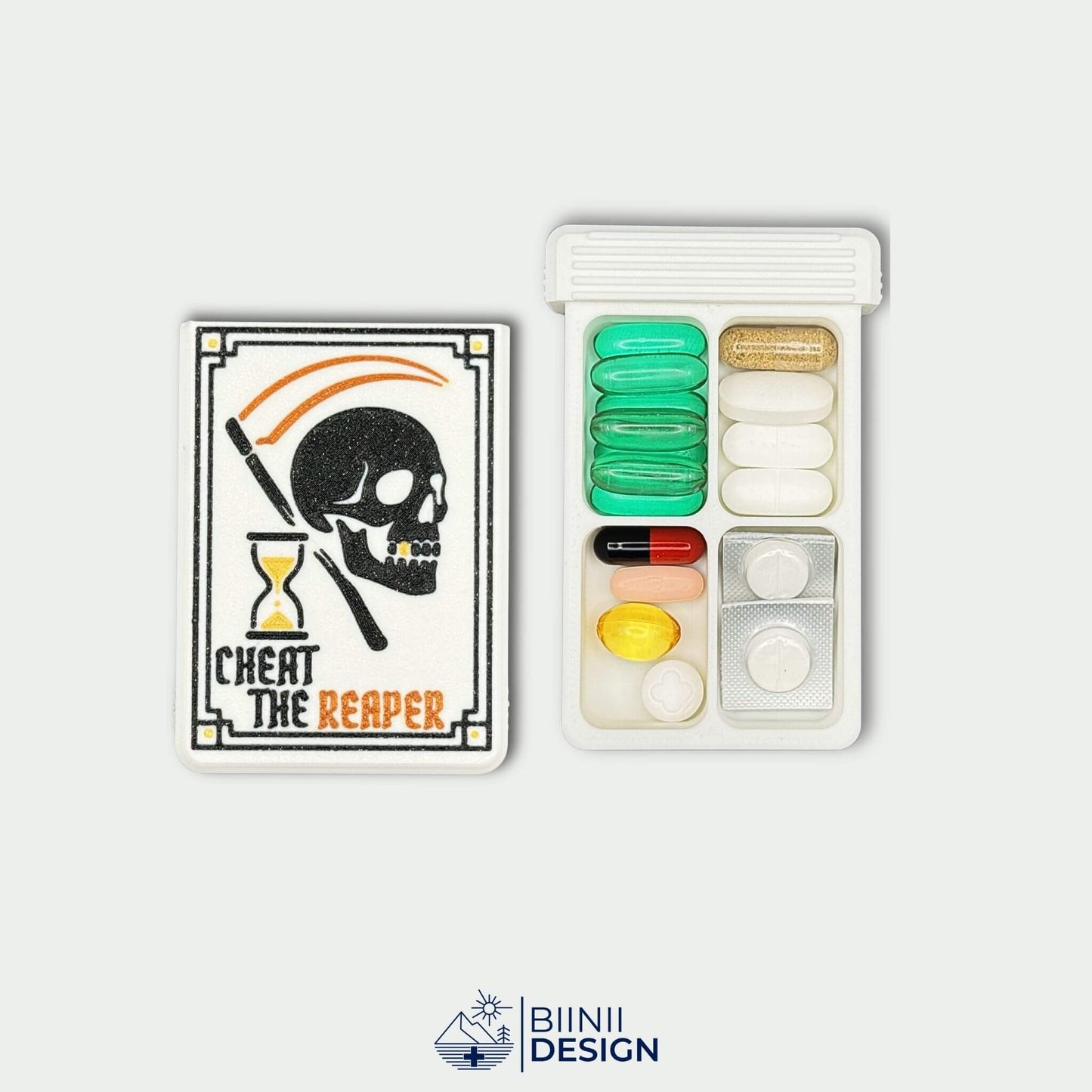 Cheat the Reaper White Edition lid beside 4 compartment tray filled with pills and capsules. Matte white gothic pill organizer.