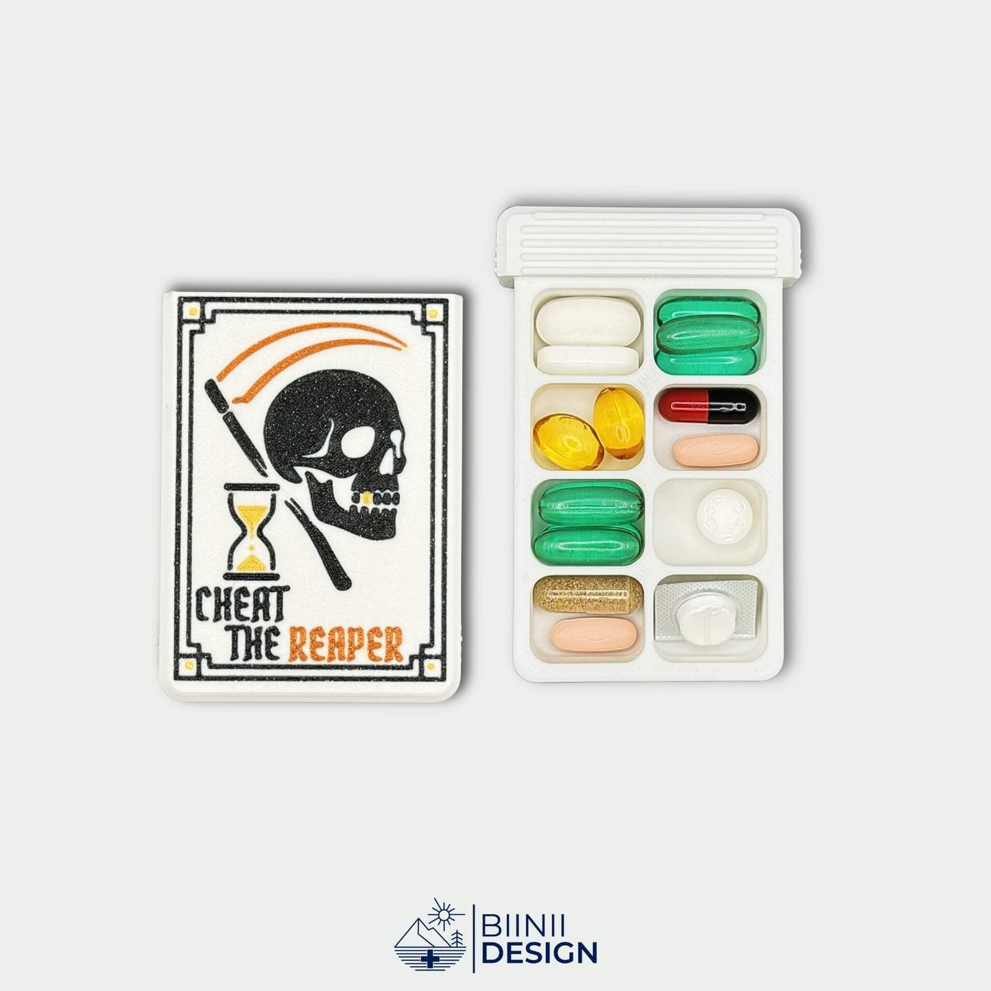 Cheat the Reaper White Edition cover beside 8 compartment weekly tray filled with medication. Large capacity pill organizer.
