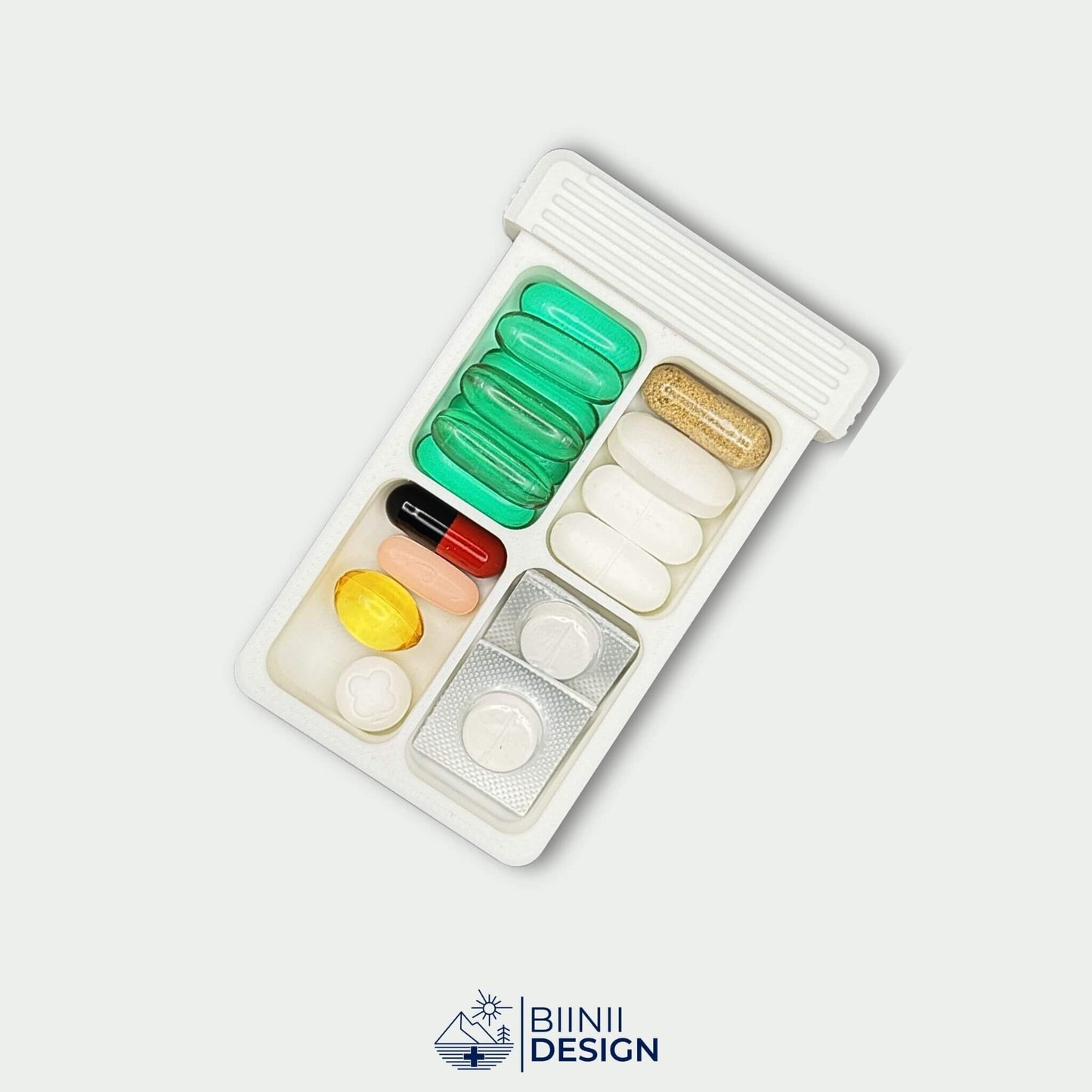 White 4-compartment pill organizer tray filled with vitamins, supplements and blisters. Compact daily pill case for medication routines.