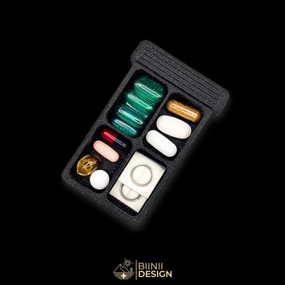 4-compartment base of the Sardines art edition pill organizer filled with a variety of tablets, capsules and supplements.