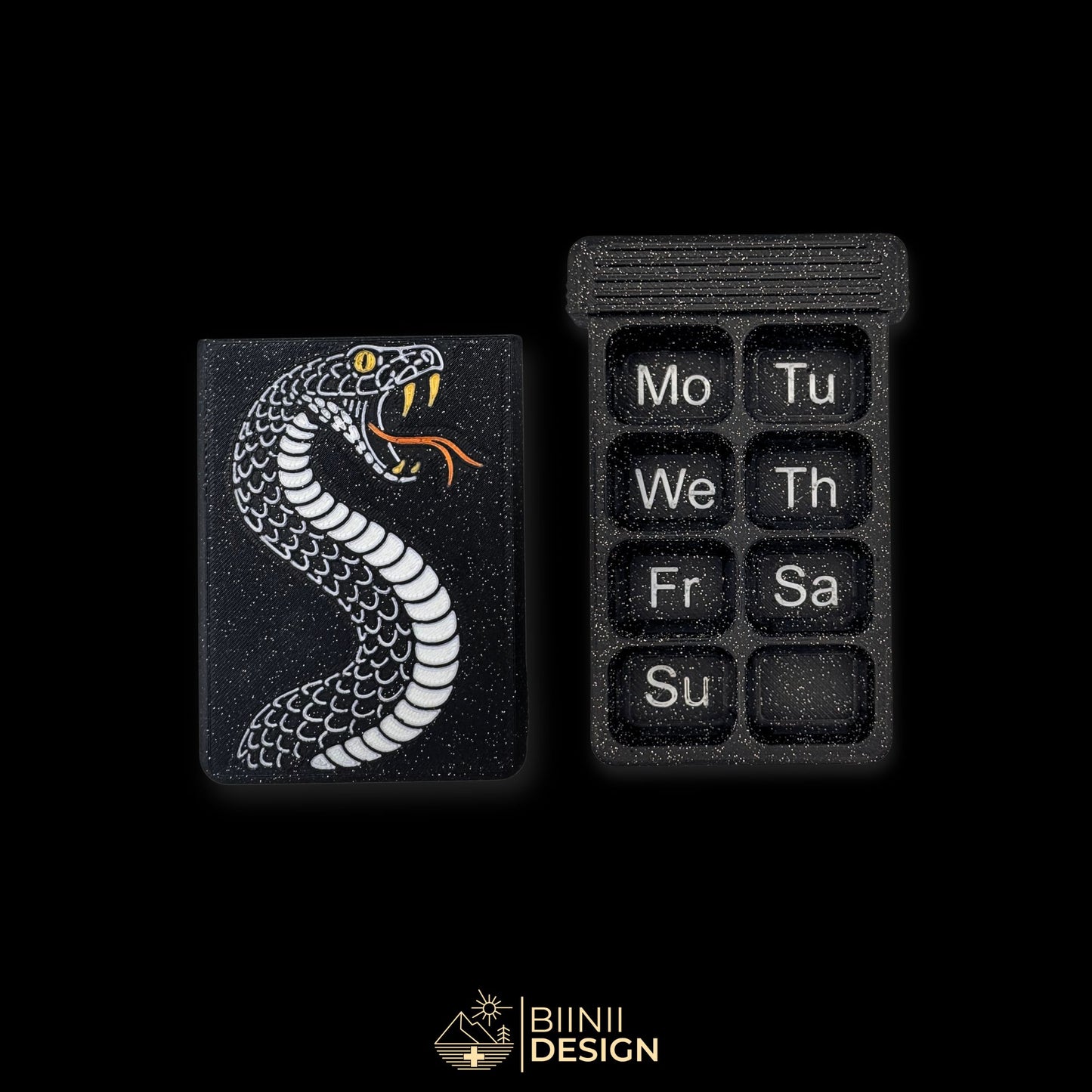 Snake cover next to empty 8 compartment tray (EN Monday start). Weekly artistic pill organizer option for English speakers.
