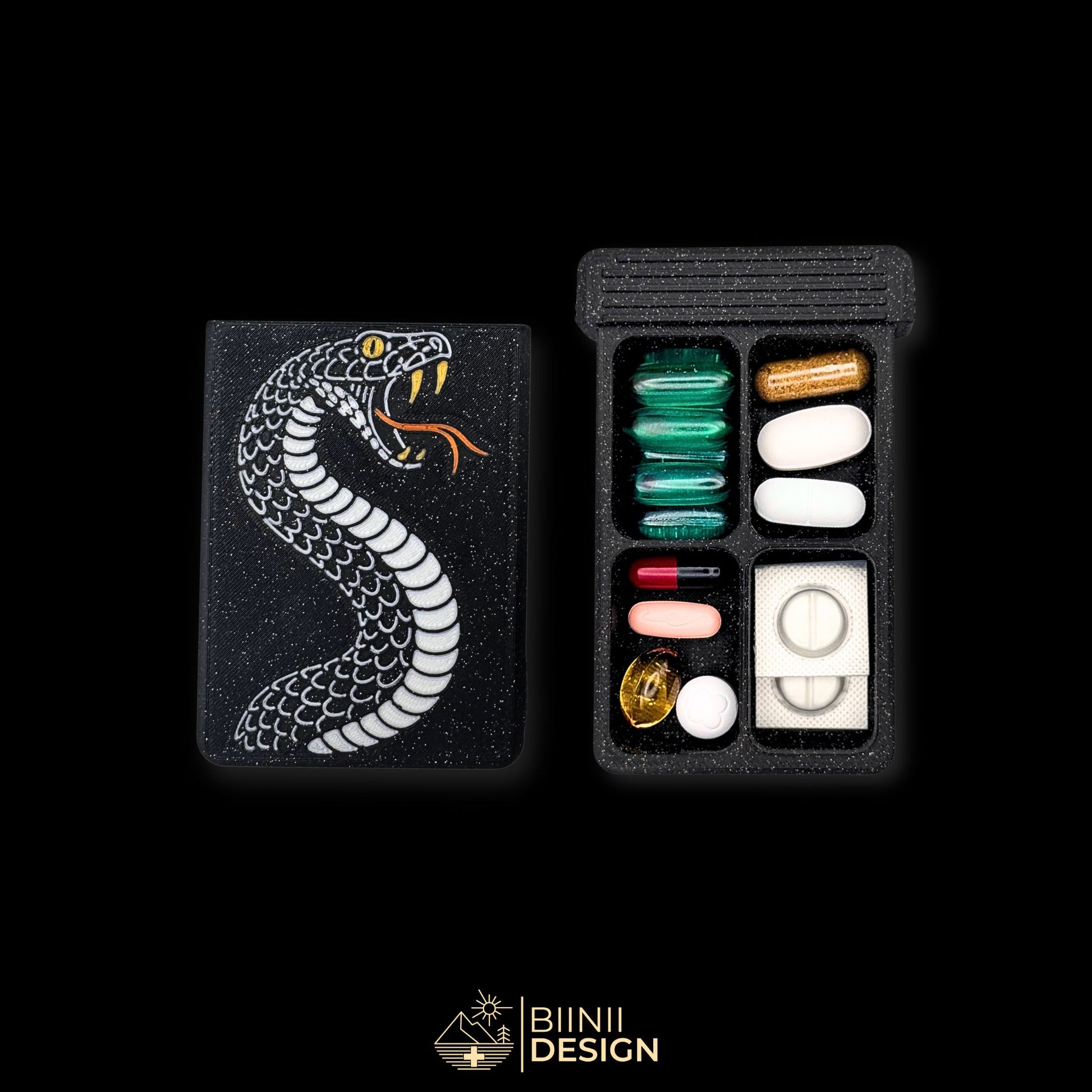 Snake cover next to 4 compartment tray. Filled with assorted supplements. Unique tattoo themed pill box.