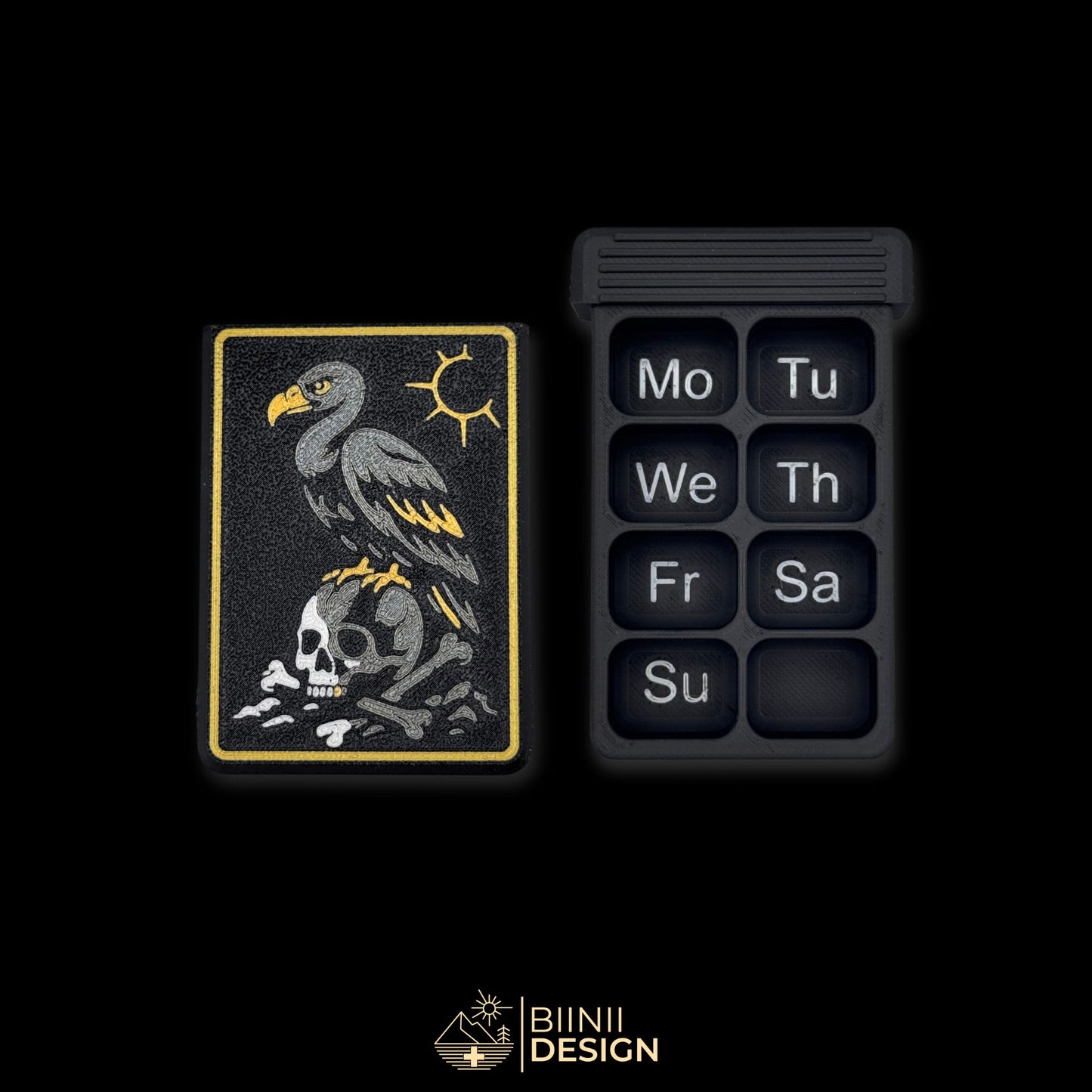 Vulture Shadow cover next to empty 8 compartment tray (EN Monday start). Weekly artistic pill organizer option for English speakers.