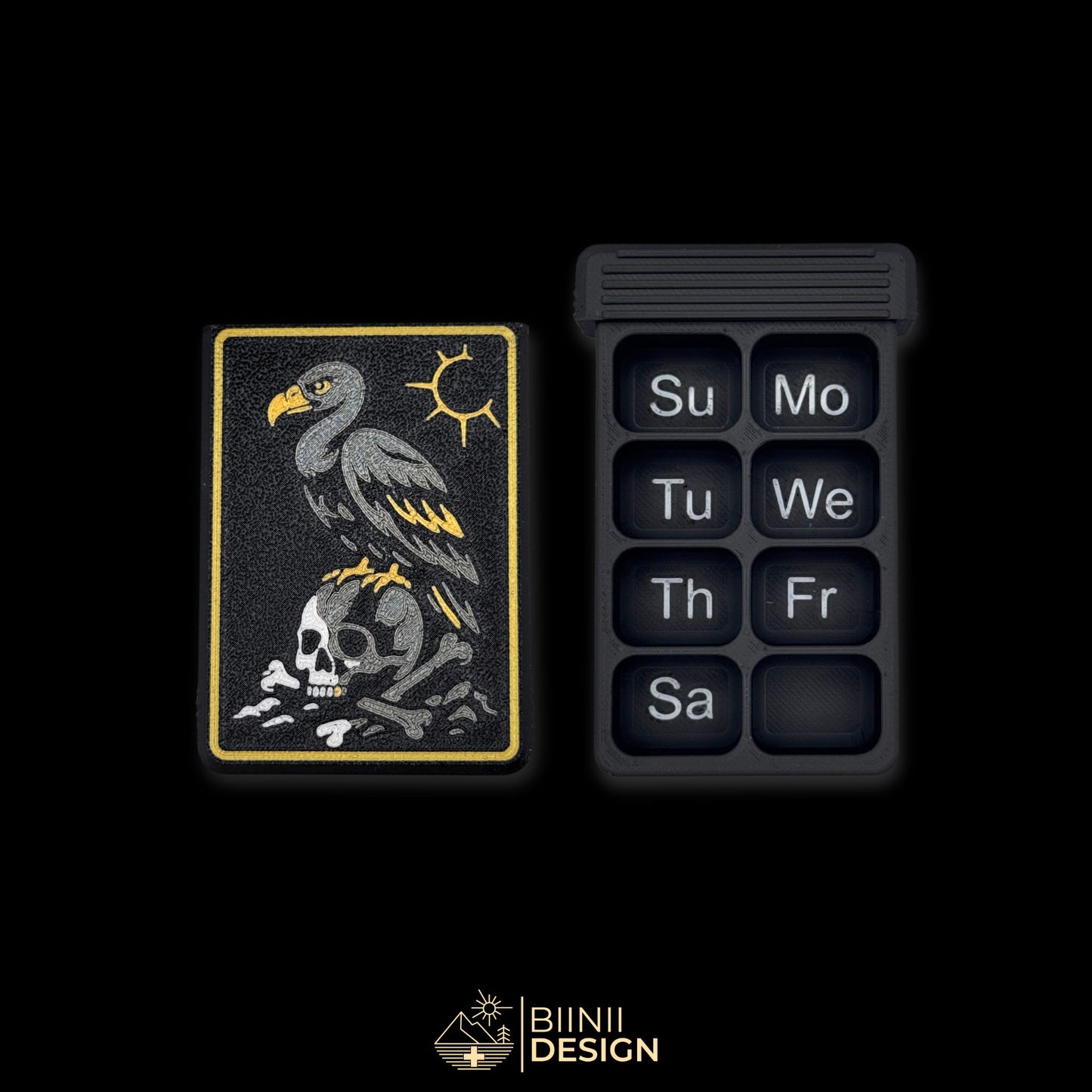 Vulture Shadow cover next to empty 8 compartment tray (EN Sunday start). Customizable pill case for 7-day routine.