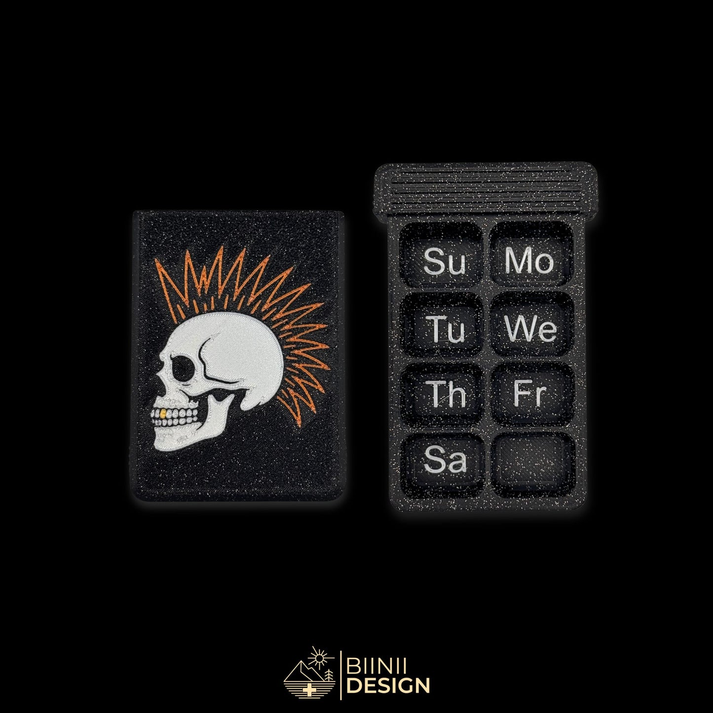 7-day punk skull pillbox in galaxy black with Sunday-start layout, Swiss-made artistic organizer with golden tooth.
Keywords: pillbox, pill organizer, weekly pill organizer, gothic